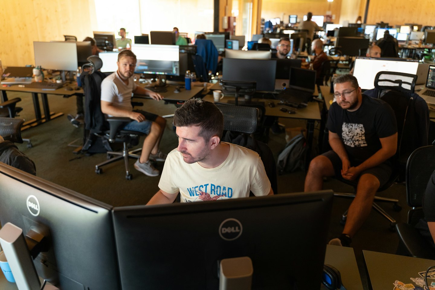 IT professionals collaborating at their desks in a modern office.